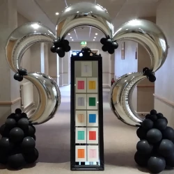 A metallic silver balloon arch