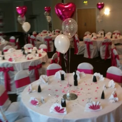 Red heart, round pearl and translucent balloons as a table centrepiece