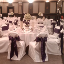 White chair covers with colour-coordinated bows