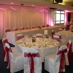 Wedding reception with luxury backdrop, chaircovers and burgundy organza sashes