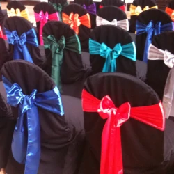 Black chair covers with assorted coloured satin sashes